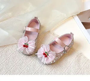 Detailed view of pink girls princess shoes featuring sparkling sequins and cherry bow