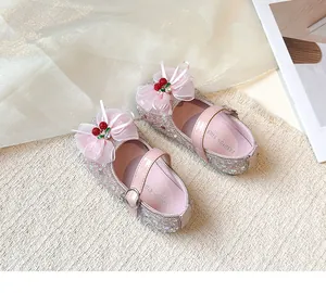Detailed view of pink glitter girls princess shoes featuring ribbon bow and cherry charm
