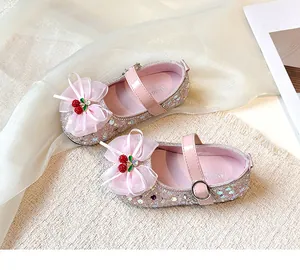 Close-up of pink glitter girl's Mary Jane shoes with mesh bow and cherry detail