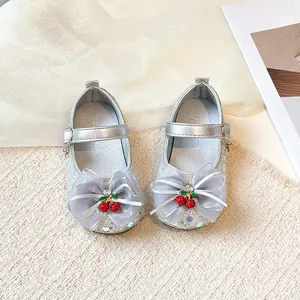 Elegant sparkly silver girls' princess shoes with large bow and cherry charm details