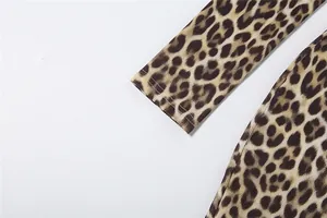 Close-up detail of leopard print long sleeve jumpsuit cuff showing fabric texture
