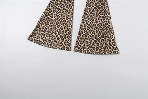 Close-up of leopard print flared jumpsuit legs with detailed hemline stitching on white background