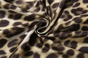 Close-up macro view of high-quality leopard print fabric texture showing soft sheen