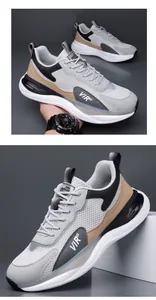 Detalle de zapatillas de running para hombre de malla gris y cuero con detalles marrones.