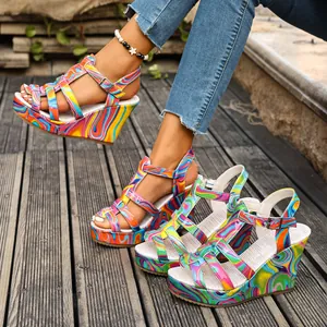 Vibrant marble print wedge sandals with buckle strap and thick sole for summer.