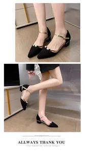 Macro view of black pointed-toe block heel pumps showcasing pearl beads and gold straps.