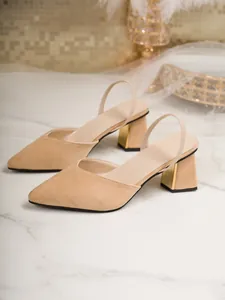 Detailed side view of elegant beige pointed-toe slingback sandals with chunky gold heels.