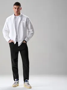 Full body shot of a male model wearing a premium white cotton shirt and black trousers
