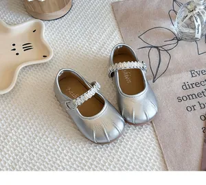 Close-up of silver Mary Jane shoes for girls with cat paw pleated toe detail