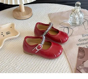 Detailed view of French style red Mary Jane leather shoes for girls in a cozy lifestyle setting