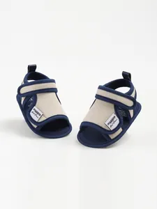 Detail view of navy and beige baby cotton walking sandals with Velcro straps