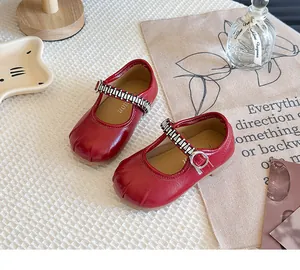 Detail view of red French-style Mary Jane shoes for girls with sparkling rhinestone buckle
