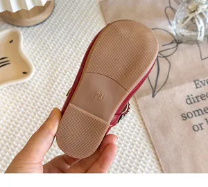 Detailed view of the anti-slip sole and size 23 stamp on red Mary Jane girls leather shoes