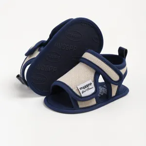 Navy blue and beige cotton baby walking sandals featuring a non-slip soft sole design