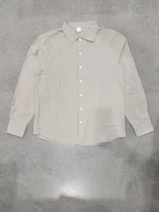 Full view of men's loose linen long-sleeved shirt in khaki with button-down collar