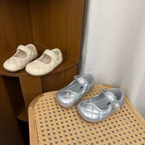 Elegant quilted children's Mary Jane shoes in beige and silver with decorative pearl accents