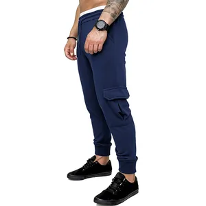 Side view detail of men's navy blue cargo joggers showing the large flap pocket design.