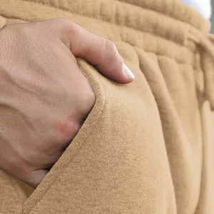 Close-up detail of side pocket and soft fabric texture on men's khaki cargo pants.