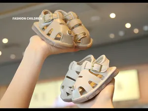 Close-up detail of anti-slip hollow-out baby walking sandals in khaki and beige tones