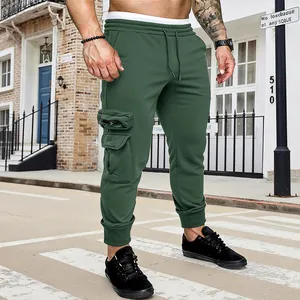 Detail view of men's green cargo joggers with functional side pockets and drawstring