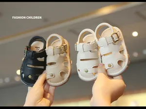 Detailed view of soft-soled hollow out baby sandals in black, beige and cream colors.