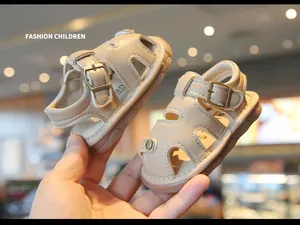 Detailed view of beige baby summer sandals featuring a hollow-out design and soft non-slip soles