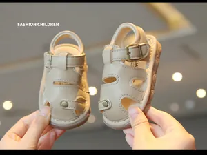 Detail of cream toddler summer sandals with hollow-out design and soft sole.