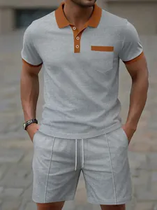 Men's grey waffle knit polo shirt and matching shorts set with orange collar detail.