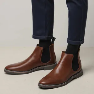 Detailed view of brown leather Chelsea boots for men with classic elastic side panels
