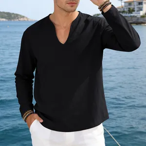 Casual men's black linen V-neck long sleeve shirt in a scenic seaside setting.