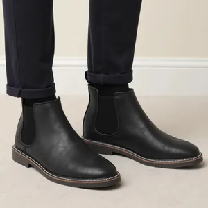 Side view of classic black leather Chelsea boots for men with elastic side panels.