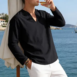 Close-up of men's loose black linen V-neck long-sleeve T-shirt in resort setting