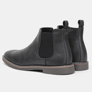 Detailed back view of retro black Chelsea boots with elastic side panels and stitching