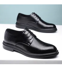 Detailed view of men's black perforated leather dress shoes for formal business wear.
