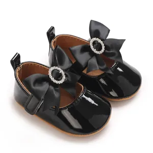 Elegant black patent leather baby shoes with large satin bow and rhinestone detail