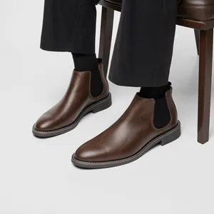 Detail of brown pebbled leather Chelsea boots for men with black elastic side panels