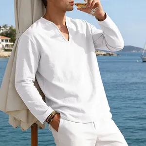 Lifestyle detail of a man wearing a white linen shirt relaxing by the blue sea