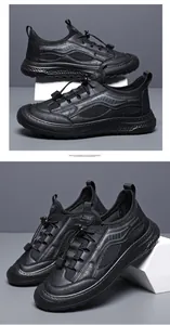 Close-up of black breathable mesh outdoor casual shoes with textured soles and drawstrings.