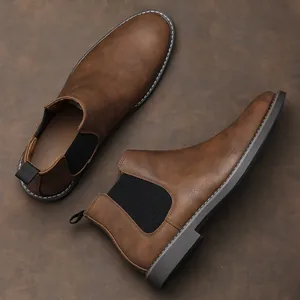 Detailed side and top view of classic brown retro Chelsea boots featuring elastic panels
