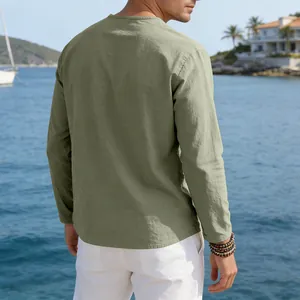 Back view of a casual sage green long-sleeved linen shirt for men in a coastal setting