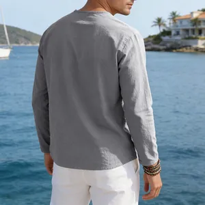 Back view of men's casual grey linen long sleeve shirt in a sunny seaside setting