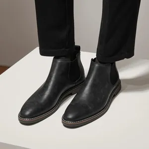 Classic black men's Chelsea boots featuring sleek retro design for formal or casual wear.