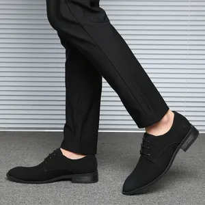 Side view detail of men's black lace-up business casual dress shoes in British style.
