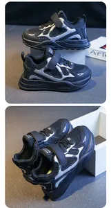 Close-up of breathable mesh and velcro strap on girls black silver sports sneakers