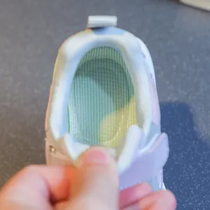 Detailed view of breathable mesh interior in kids' soft-sole running shoes for girls