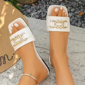 White flat slide sandals with decorative gold chain and square toe for summer wear