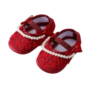 Elegant red soft sole baby princess shoes featuring delicate pearls and a bow