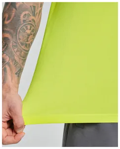Close-up of neon yellow breathable mesh fabric on seamless men's sports tank top