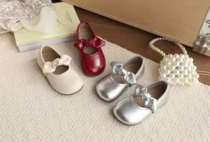 Variety of girls' bow princess shoes in beige, red, and silver metallic finishes.