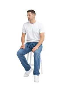Classic men's blue straight-leg jeans shown on a model sitting on a white stool